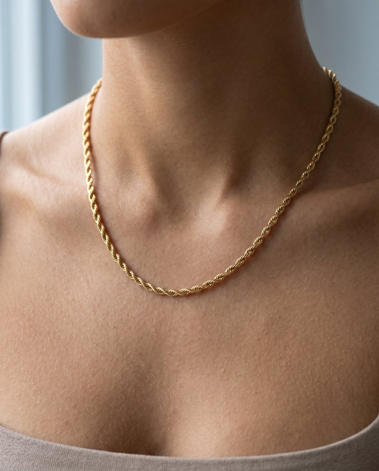 Fine gold-plated stainless steel necklace on a warm-toned collarbone showing comfortable all-day wear