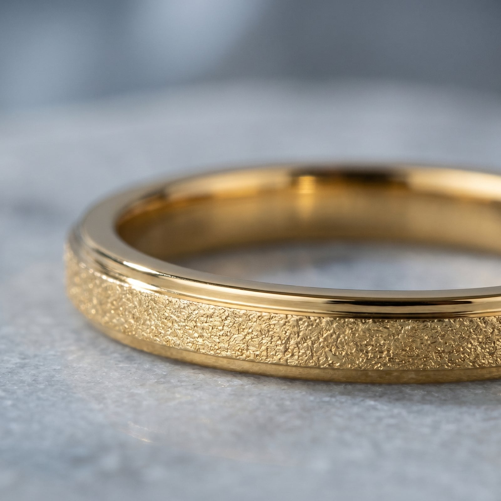 Extreme macro of a smooth gold-plated stainless steel piece showing a flawless continuous metal surface