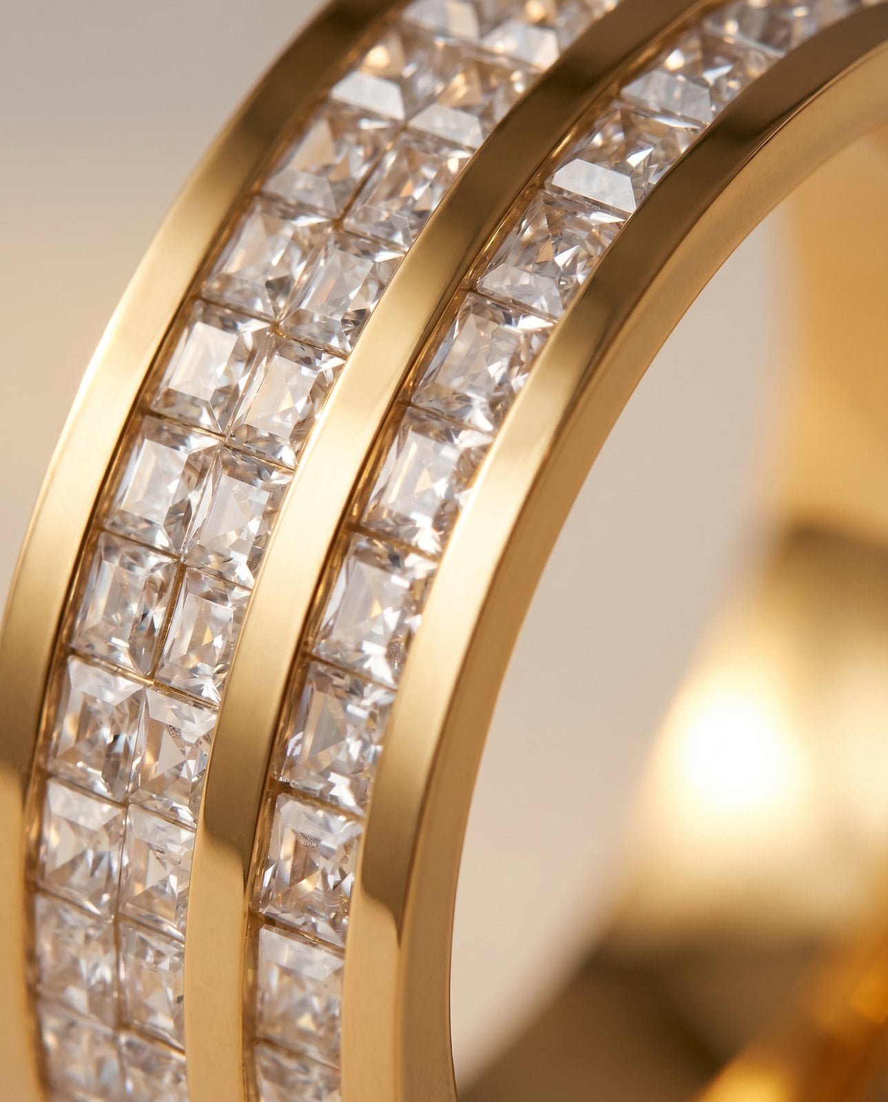 Extreme macro of a gold-plated band's polished edge and warm reflective surface finish