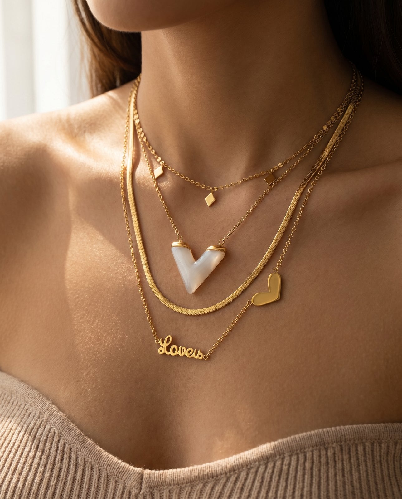 Collarbone layered with two or three mixed dainty gold-plated necklaces of varying lengths